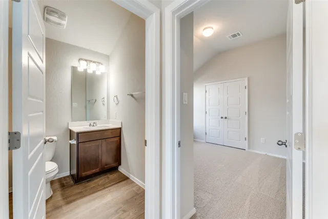wooden floor with a mirror and a sink