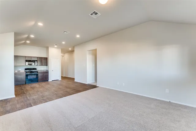 a view of kitchen and hall with stainless steel appliances
