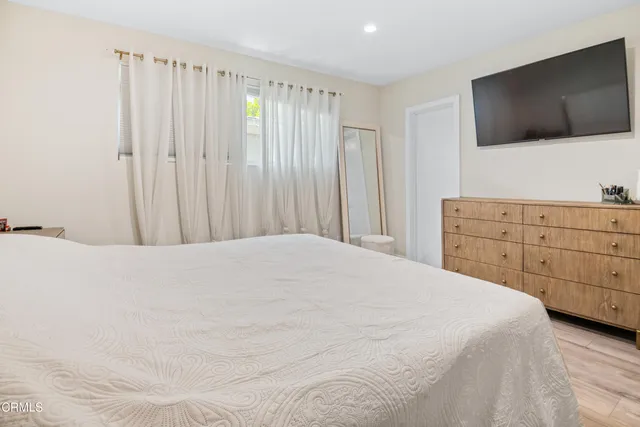a bedroom with a bed and a flat screen tv