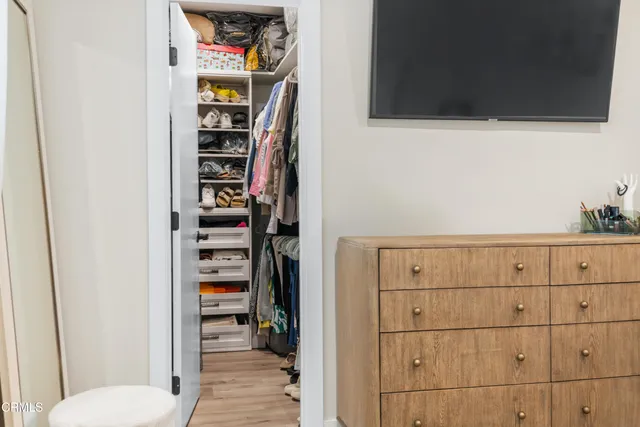 a view of closet with wooden floor