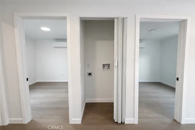 an empty room with closet and mirror