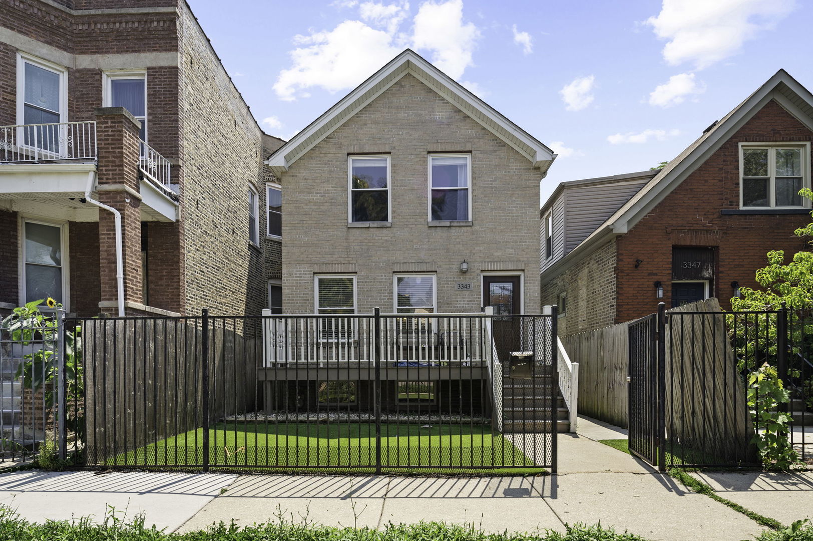 3343 West Potomac Avenue Chicago, IL 60651 - Photo 1 of 44 a view of a house with wooden fence
