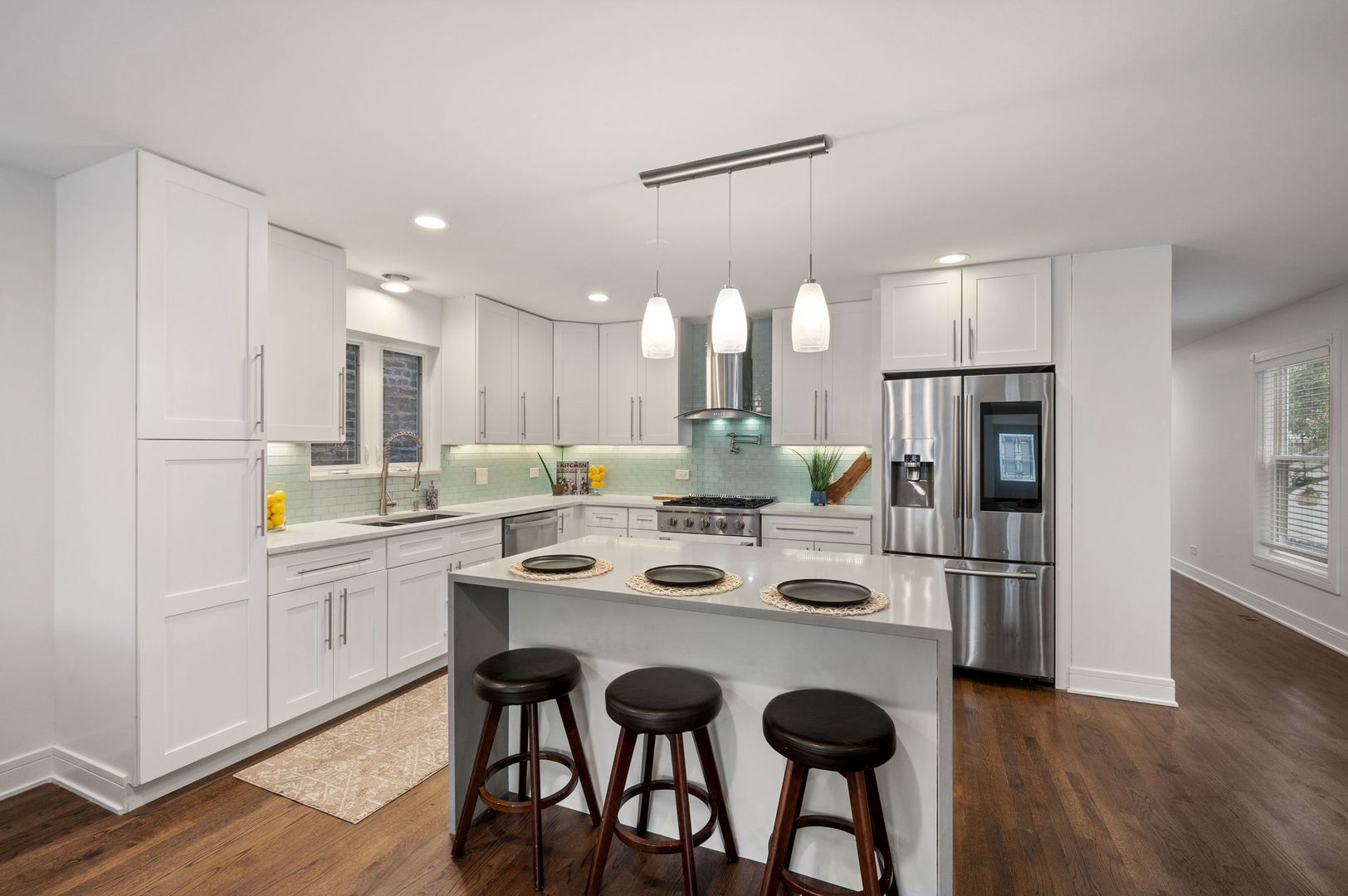 3343 West Potomac Avenue Chicago, IL 60651 - Photo 11 of 44 a kitchen with white cabinets and stainless steel appliances