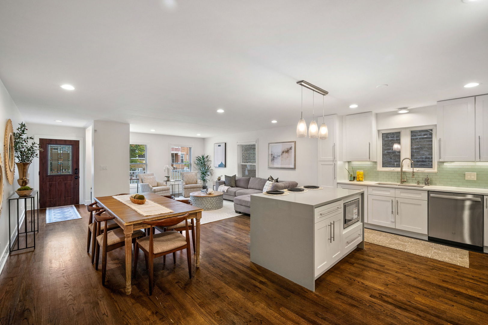 3343 West Potomac Avenue Chicago, IL 60651 - Photo 12 of 44 a kitchen with a stove a table and chairs in it