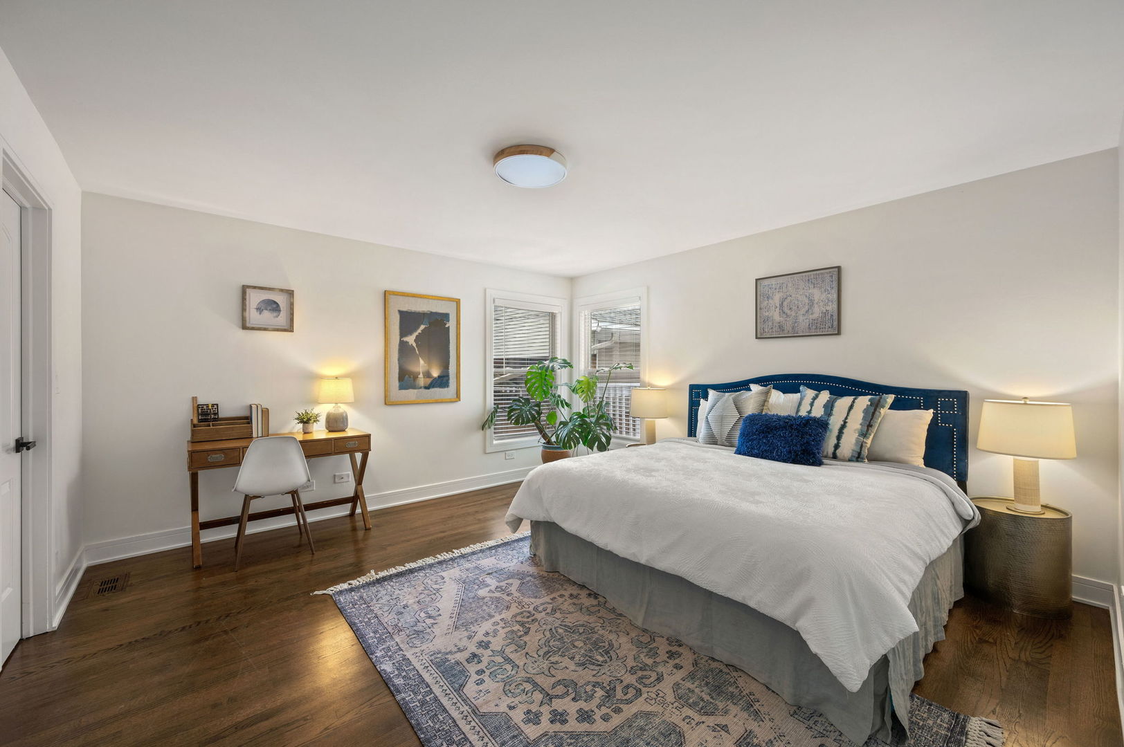 3343 West Potomac Avenue Chicago, IL 60651 - Photo 13 of 44 a bedroom with a large bed and a wooden floor