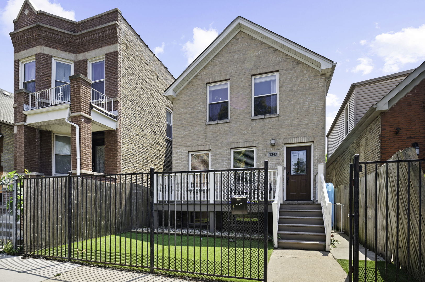 3343 West Potomac Avenue Chicago, IL 60651 - Photo 2 of 44 a front view of a house with iron fence
