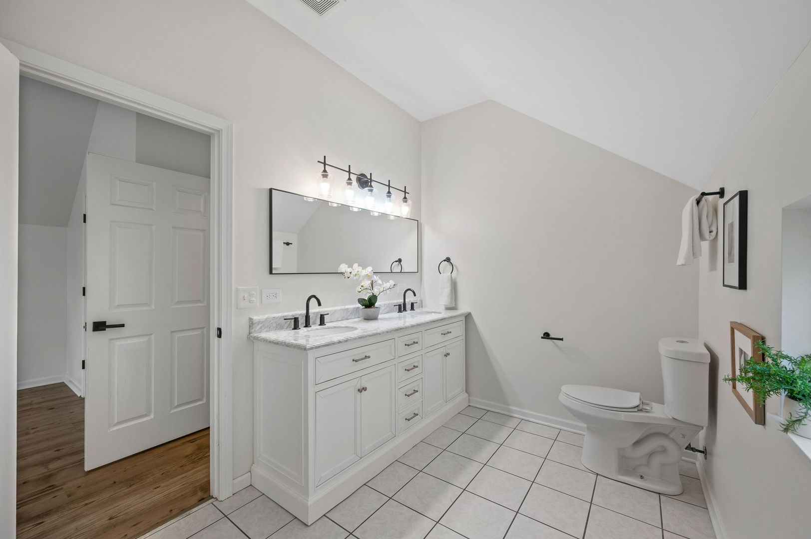 3343 West Potomac Avenue Chicago, IL 60651 - Photo 21 of 44 a spacious bathroom with a granite countertop sink a toilet and a mirror