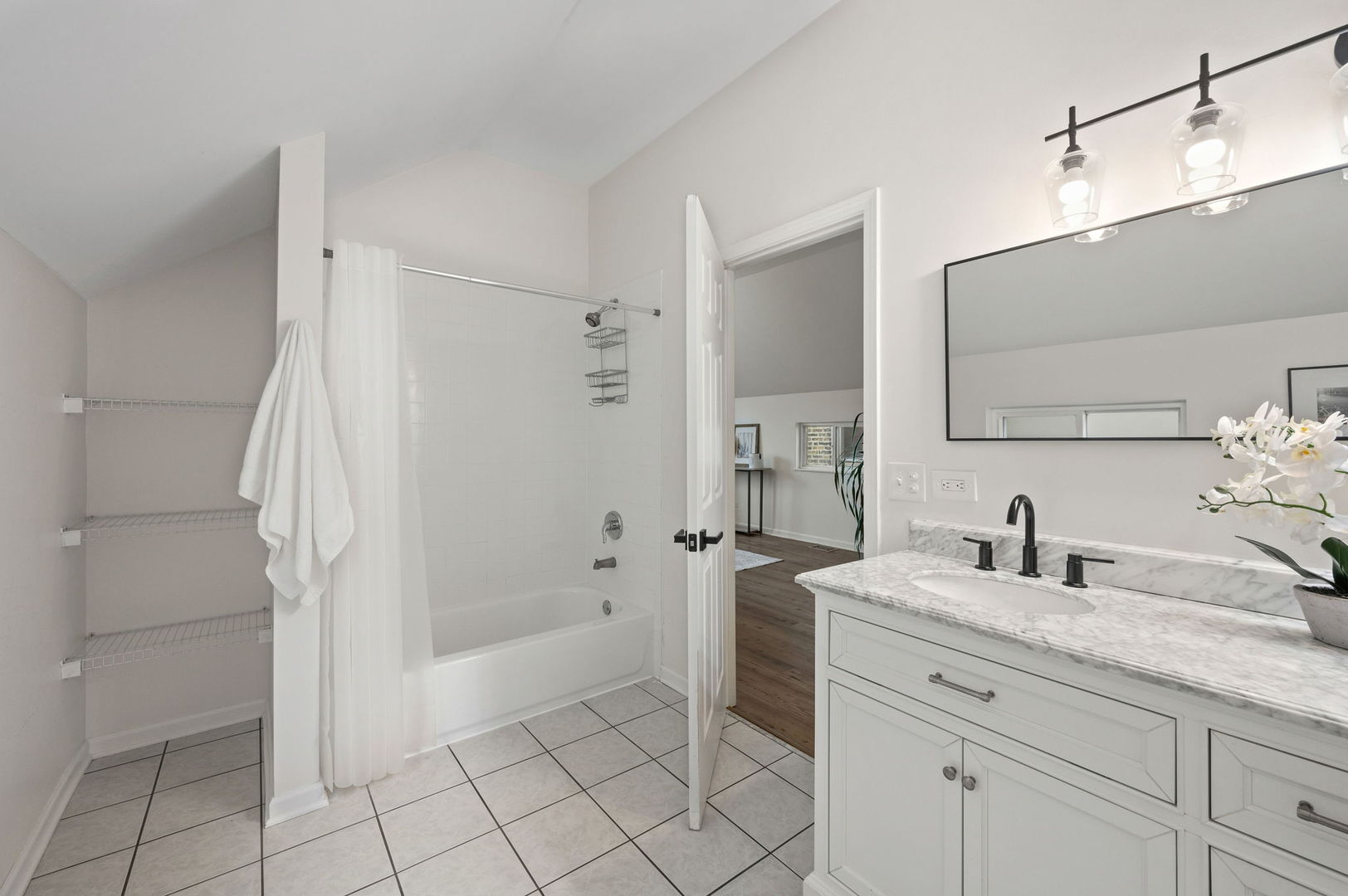 3343 West Potomac Avenue Chicago, IL 60651 - Photo 23 of 44 a bathroom with a granite countertop sink a mirror and shower