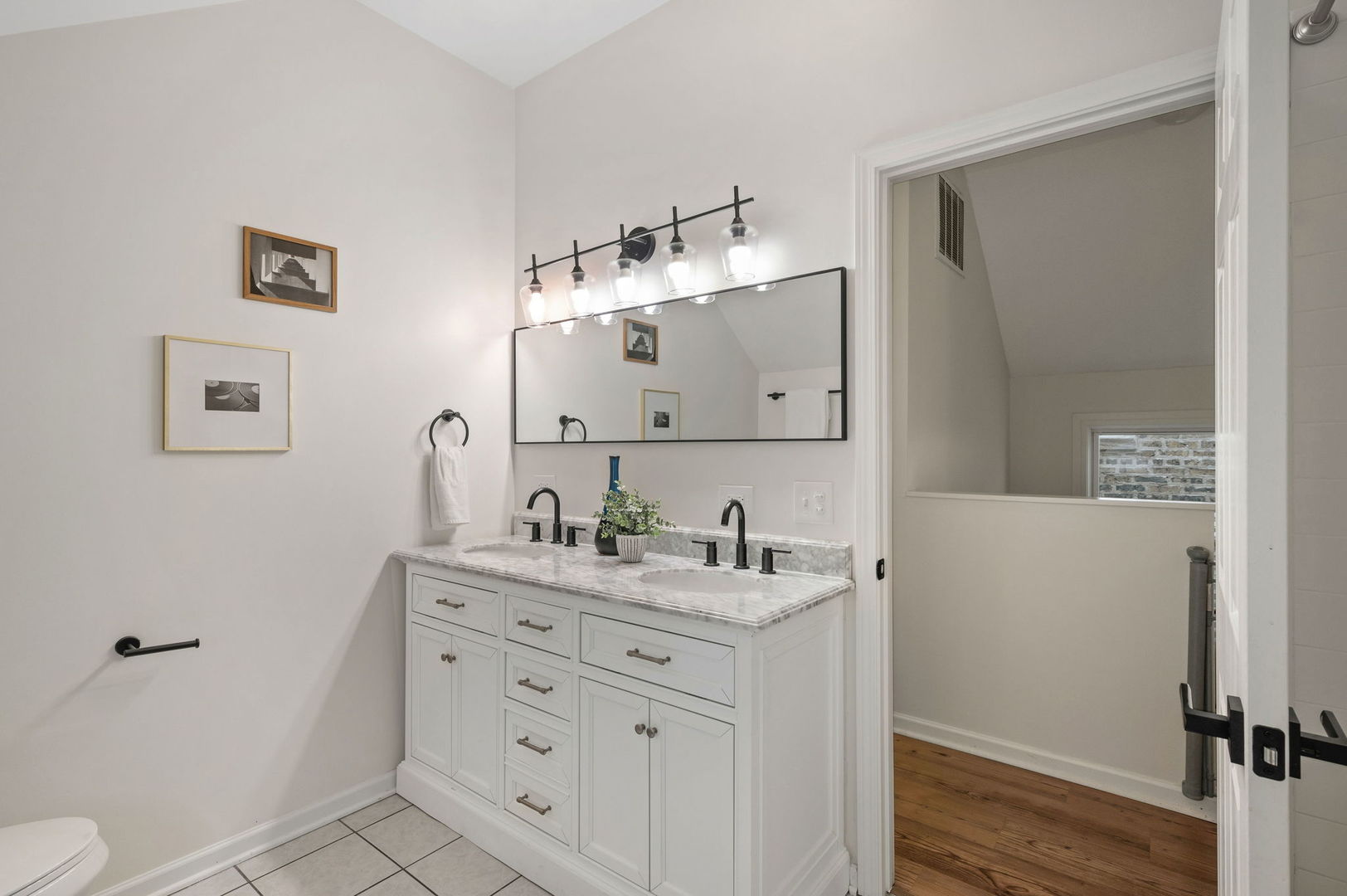 3343 West Potomac Avenue Chicago, IL 60651 - Photo 27 of 44 a bathroom with a sink a toilet and a mirror