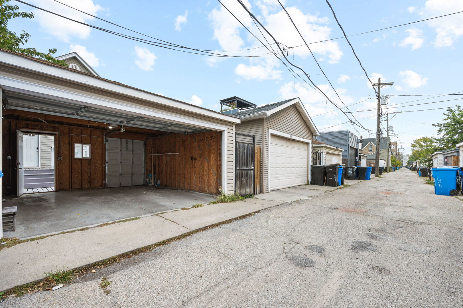 3343 West Potomac Avenue Chicago, IL 60651 - Photo 40 of 44 a view of a house with potted plants and wooden fence