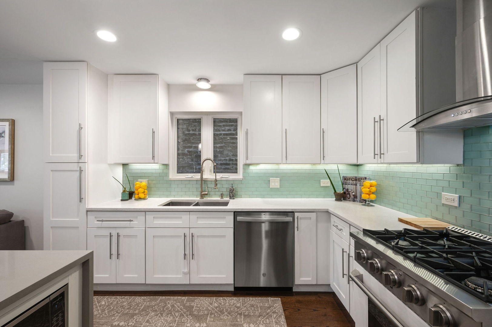 3343 West Potomac Avenue Chicago, IL 60651 - Photo 9 of 44 a kitchen with stainless steel appliances a stove a sink a refrigerator a counter space and cabinets