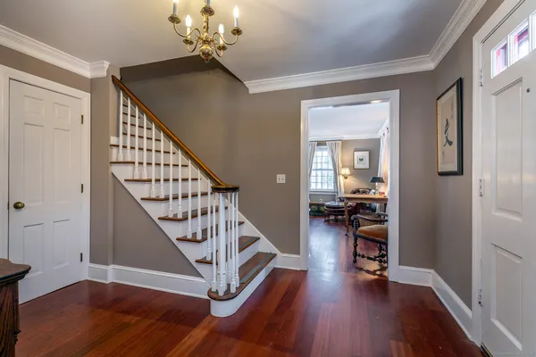 a view of a livingroom with wooden floor and stairs