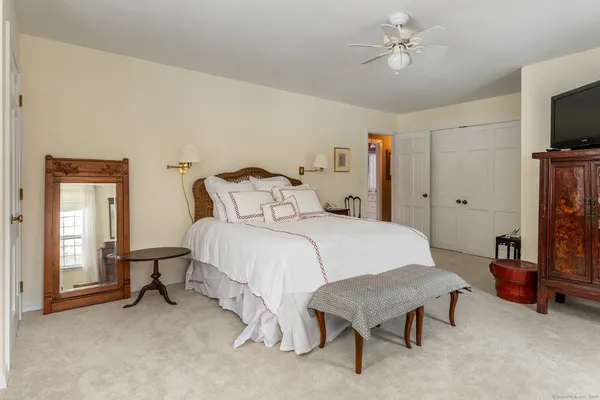 a bedroom with a bed and a flat screen tv