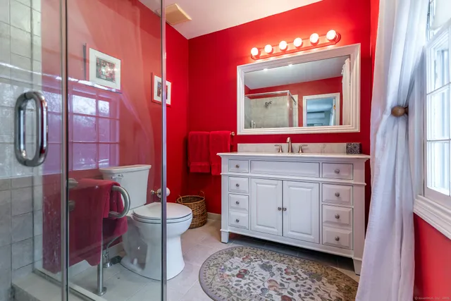 a room with a chair and dresser