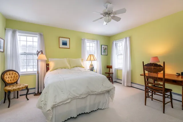 a spacious bedroom with a bed and a chandelier