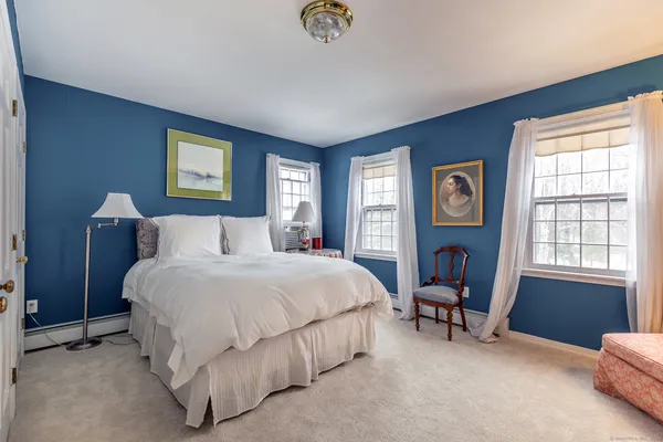 a bedroom with bed and a window