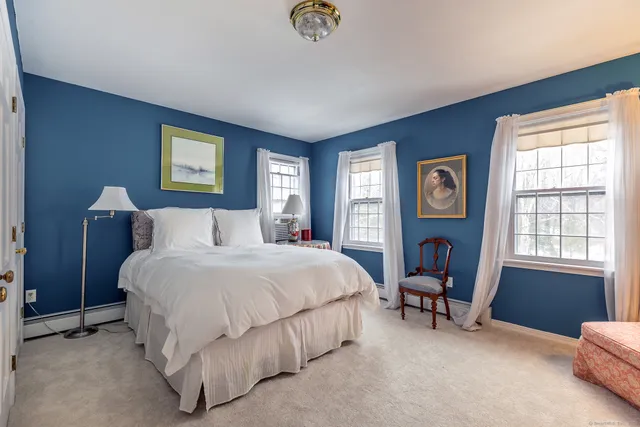 a bedroom with bed and a window