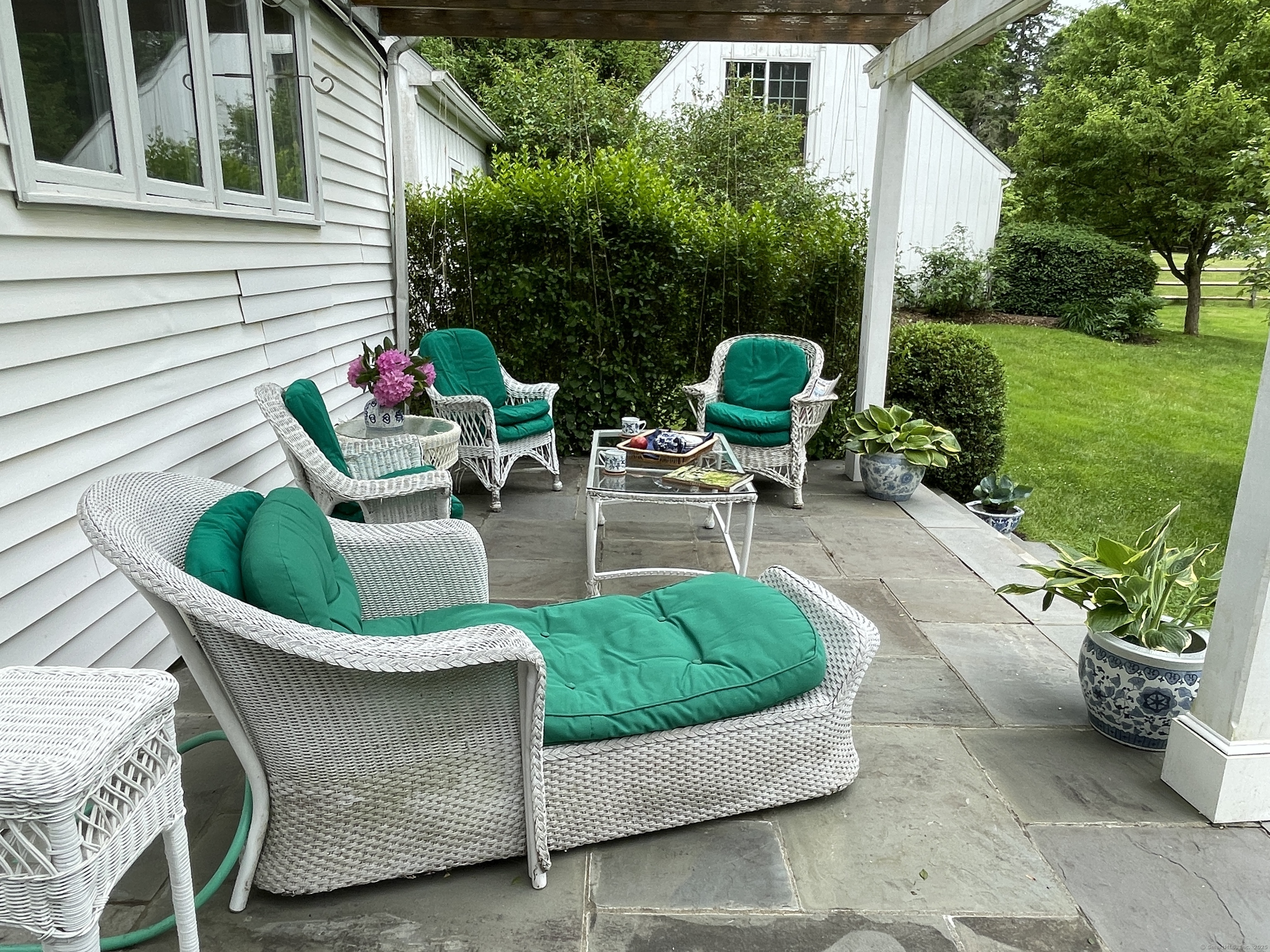 5 North Street Roxbury, CT 06783 - Photo 26 of 28 a view of a chair and table in back yard of the house