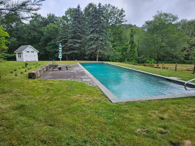 a view of a mini pool with a yard