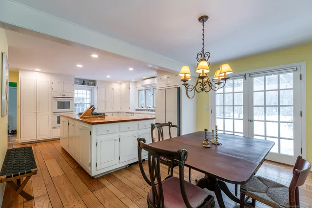 a kitchen with a table and chairs