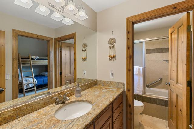 755 South Zion Ridge Drive Orderville, UT 84758 - Photo 57 of 84 Ensuite bathroom with vanity, tiled shower / bath, and light tile patterned flooring