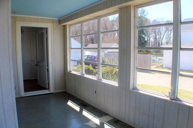 9593 Atlantic Road Atlantic, VA 23303 - Photo 11 of 20 a view of an empty room with wooden floor and a window