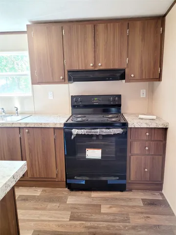 a kitchen with granite countertop a stove and a sink