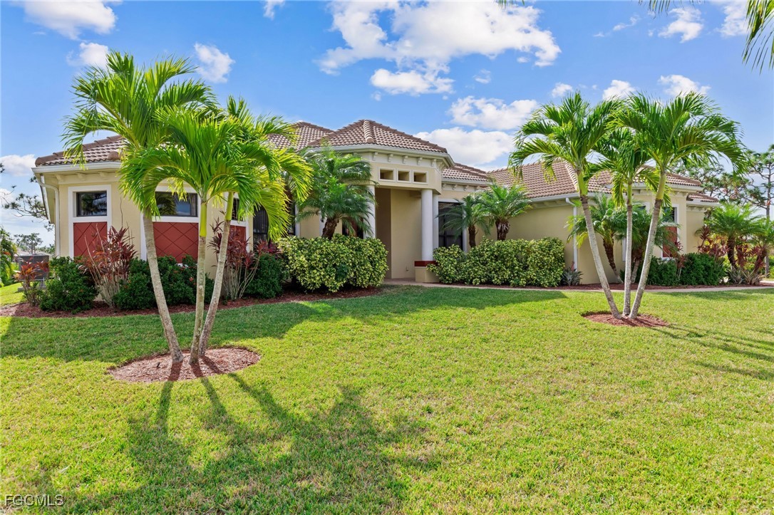 6057 Calusa Rdg Trail Bokeelia, FL 33922 - Photo 39 of 45 a house with garden in front of it