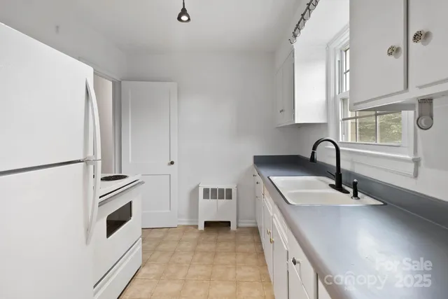 a kitchen with a sink and a refrigerator