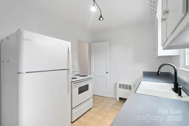 a white refrigerator freezer sitting inside of a kitchen