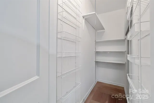 a view of walk in closet with empty racks