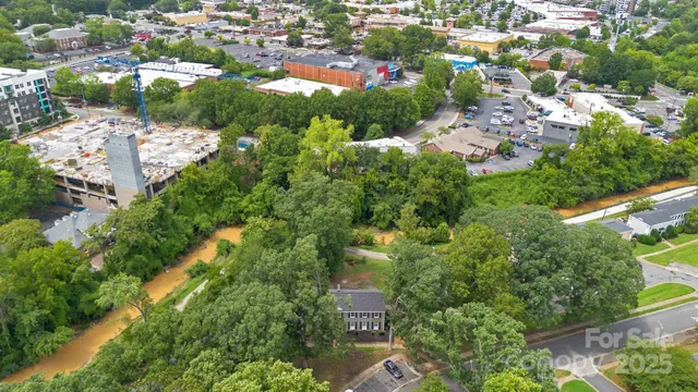 an aerial view of a house with a yard and lake view
