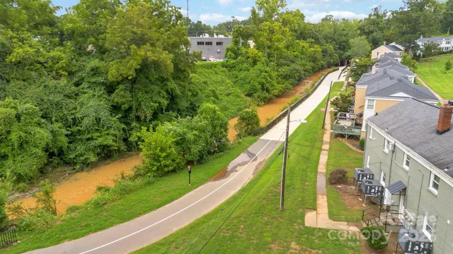 an aerial view of a house with a yard and lake view