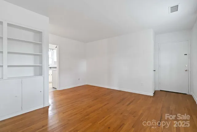an empty room with wooden floor