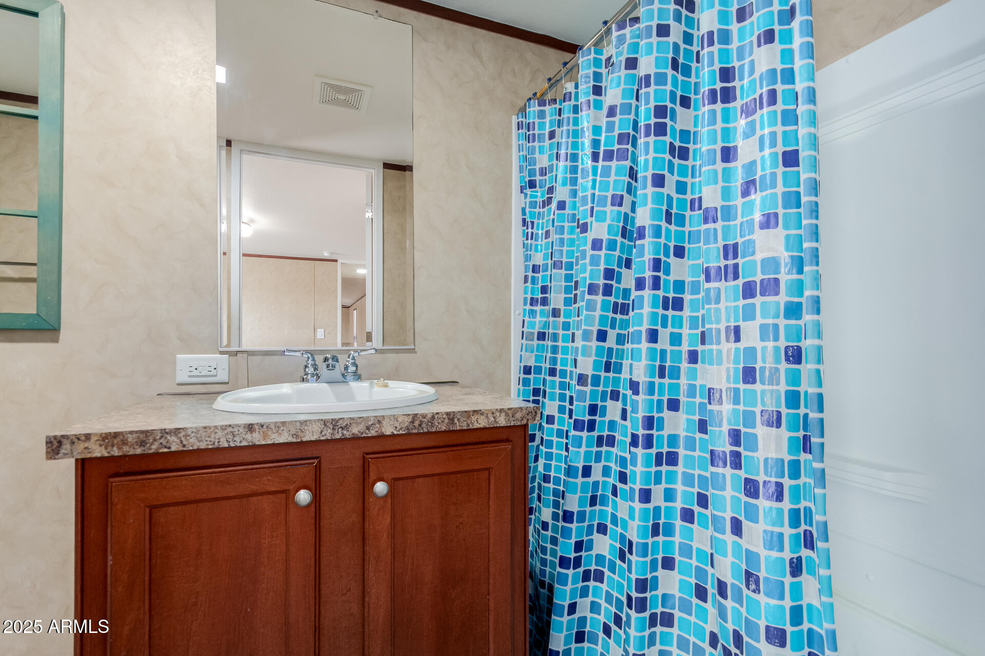 2000 South Apache Road, Unit 395 Buckeye, AZ 85326 - Photo 15 of 36 a bathroom with a granite countertop sink a mirror and shower