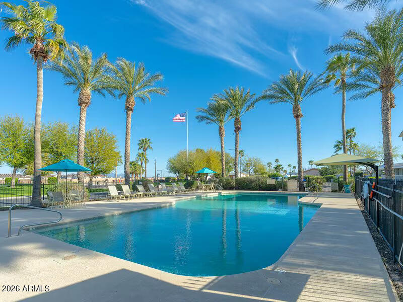 2000 South Apache Road, Unit 395 Buckeye, AZ 85326 - Photo 34 of 36 a view of a swimming pool with a table and chairs