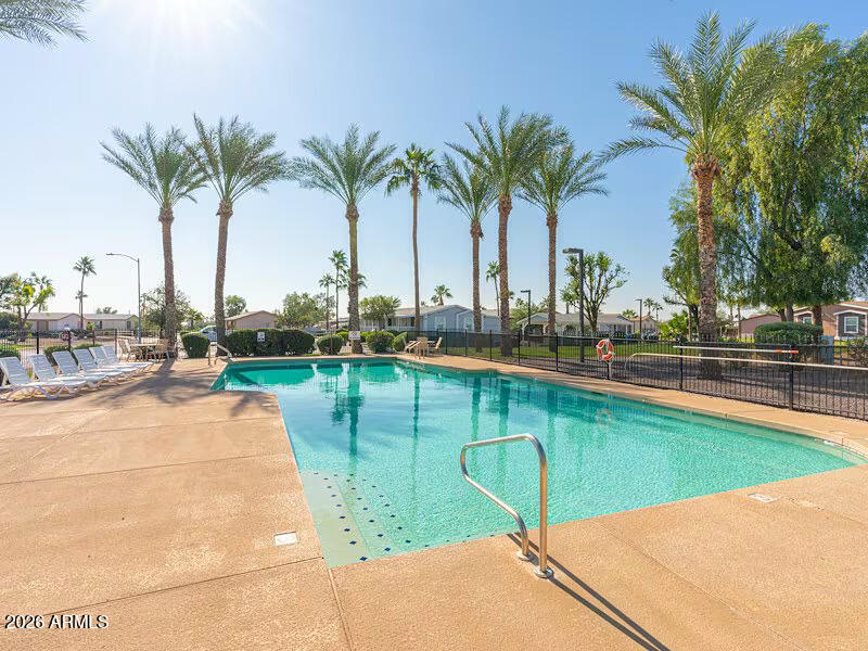 2000 South Apache Road, Unit 395 Buckeye, AZ 85326 - Photo 35 of 36 a view of swimming pool with outdoor seating and yard