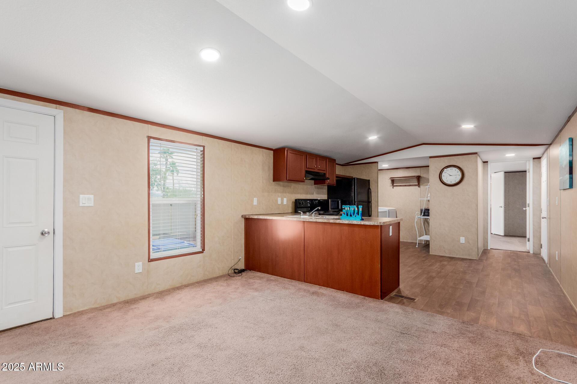 2000 South Apache Road, Unit 395 Buckeye, AZ 85326 - Photo 8 of 36 an empty room with kitchen and windows
