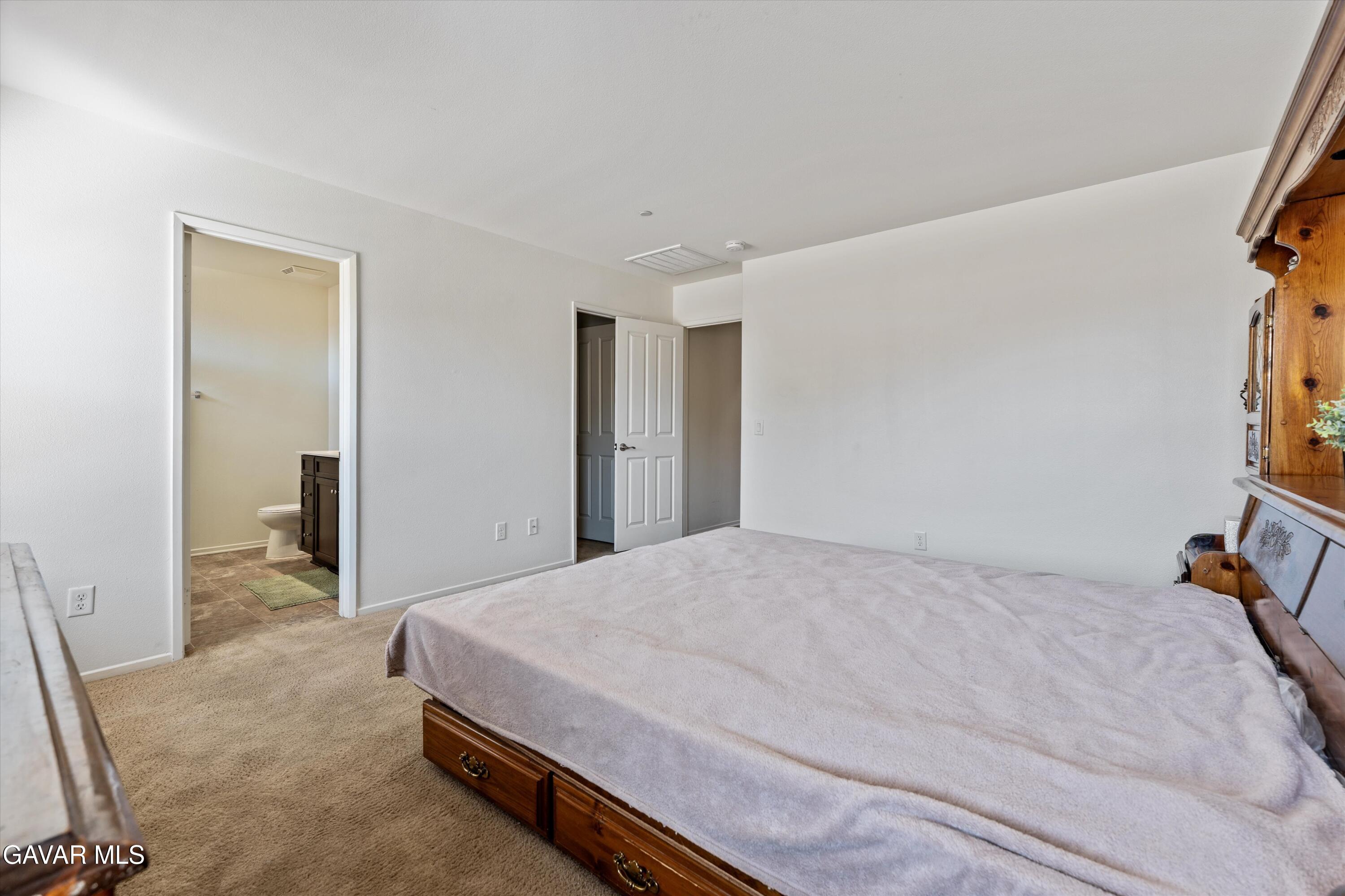 1754 West Milling Street Lancaster, CA 93534 - Photo 13 of 24 a spacious bedroom with a bed and a cabinets