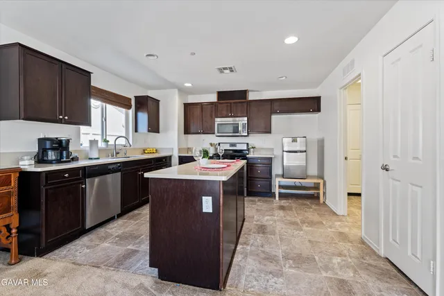 a kitchen with a sink a counter top space and cabinets