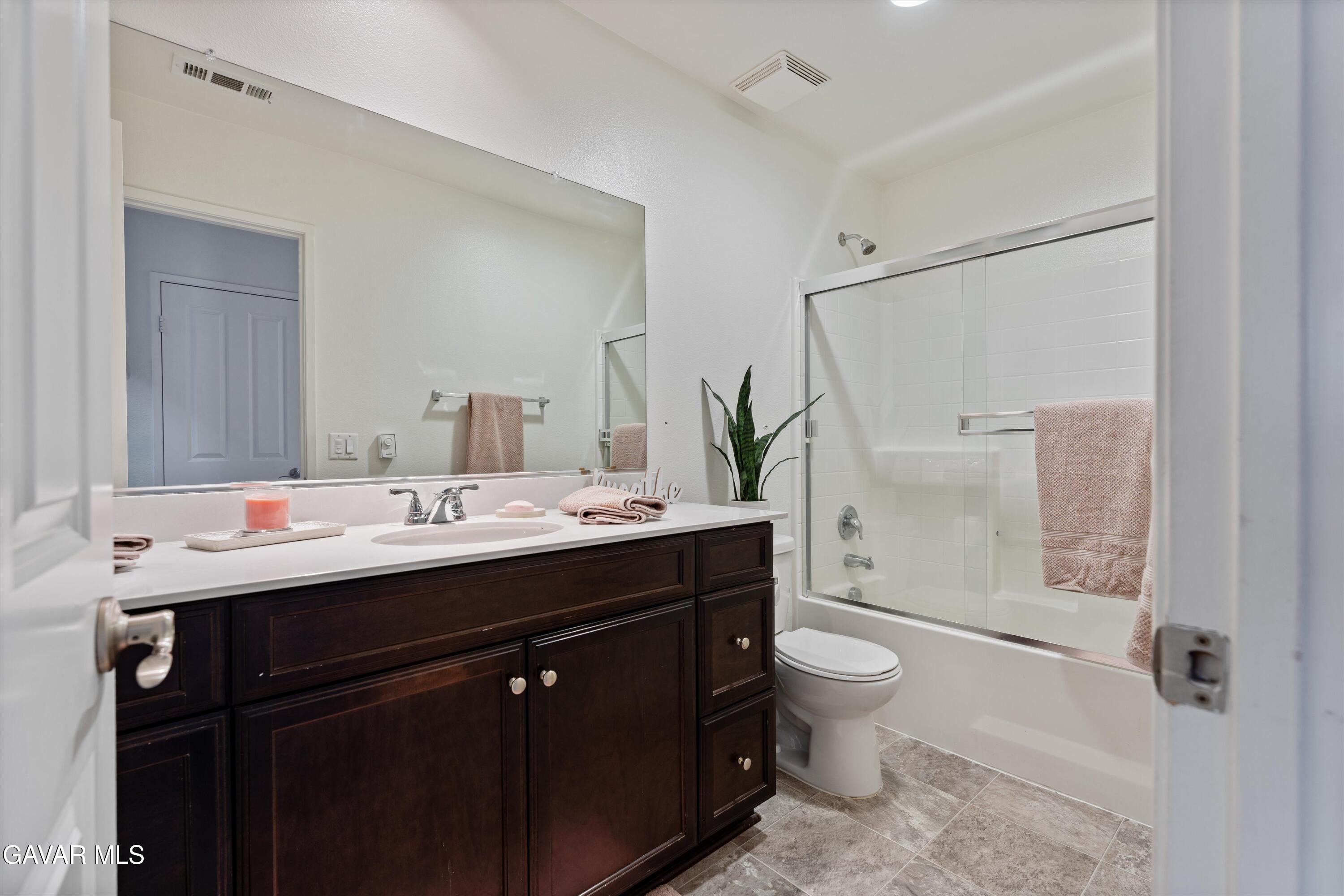 1754 West Milling Street Lancaster, CA 93534 - Photo 10 of 24 a bathroom with a double vanity sink toilet and shower