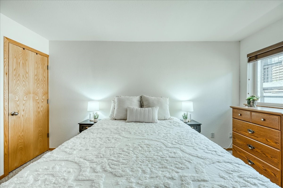 91399 Ryan Gulch Road, Unit B6 Silverthorne, CO 80498 - Photo 19 of 36 a bedroom with a bed and a window