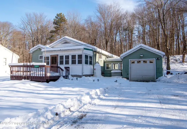 a view of a house with a yard and fence