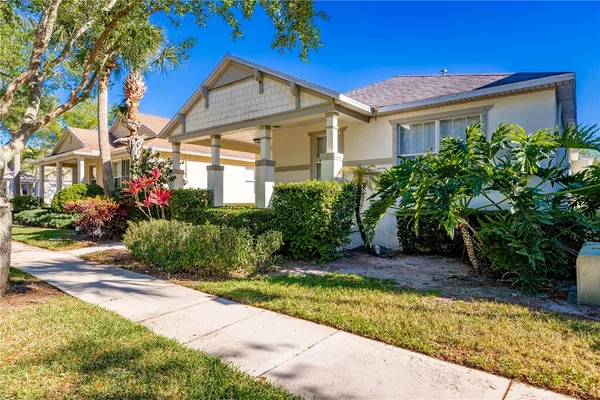 a view of a house with potted plants