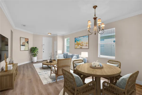 a view of a dining room with furniture wooden floor and a chandelier