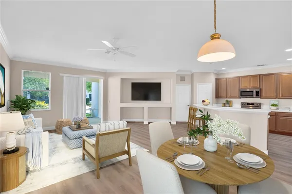 a living room with furniture kitchen view and a chandelier