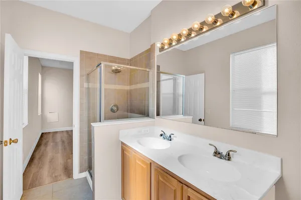 a bathroom with a sink double vanity and a mirror