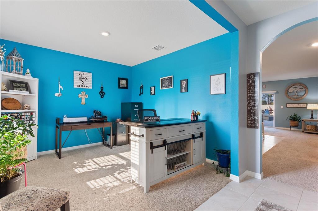 856 Sun Burst Road Winter Haven, FL 33880 - Photo 13 of 54 a kitchen with stainless steel appliances kitchen island granite countertop a stove a sink and a refrigerator