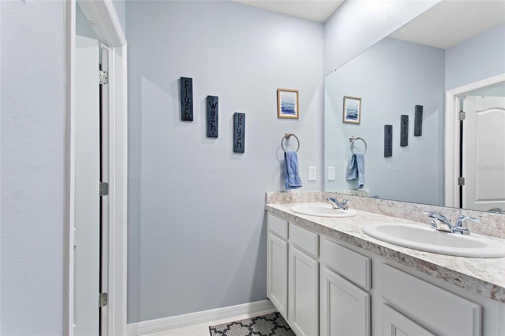 856 Sun Burst Road Winter Haven, FL 33880 - Photo 29 of 54 a bathroom with a granite countertop sink and a mirror