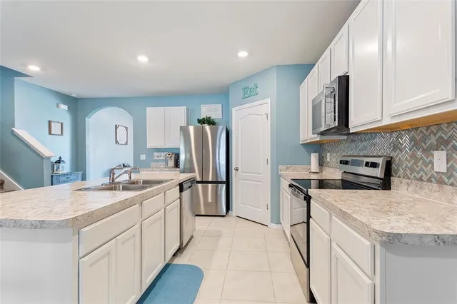 a kitchen with a sink stove and refrigerator